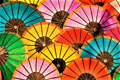 Multicoloured hand made paper umbrellas or parasols on sale at the handicraft evening market in Luang Prabang, Laos, Southeast Asia